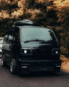 a black van is parked on the side of the road