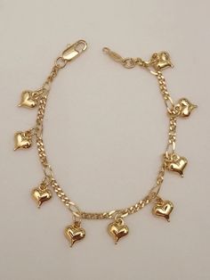 a gold bracelet with heart charms on it