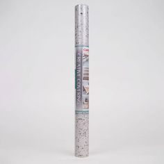 a roll of silver glitter paper sitting on top of a white surface