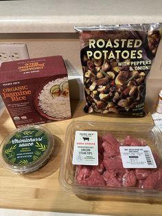 some food items are sitting on a counter top next to a bag of potato chips