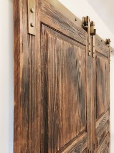 an image of a wooden door with metal handles