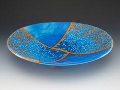 a blue and orange plate on a gray background