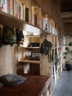 a room filled with lots of wooden shelves and books on top of eachother