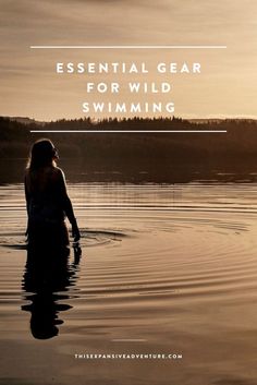 a woman swimming in the water with text overlay that reads essential gear for wild swimming