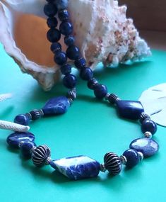 "Dress up your denims or casual outfits with this 28in. Sodalite and Silver necklace. Features 20mm sodalite coin beads and 30mm diamond focal beads with corrugated silver beads.  Includes graduated (12mm to 6mm) round sodalite beads with silver caps. Toggle clasp. Improve your communications with this third chakra stone. Sodalite is the the \"TRUTH SEEKER\" stone." Beads Dress, Third Chakra, Art Nouveau Necklaces, Truth Seeker, Silver Caps, Focal Beads, Ann Arbor, Chakra Stones, Focal Bead