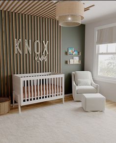 a baby's room with a white crib and chair