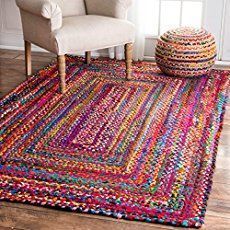 a multicolored rug with a white chair in the background