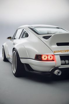 the rear end of a white sports car