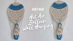 two crocheted hot air balloons hanging from strings with text that reads, habitt made hot air balloon wall hangings