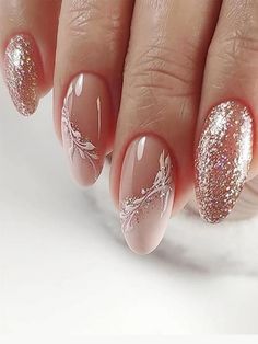 a woman's hand with pink and gold nail polishes on her nails,