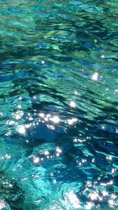 the water is very clear and blue with little white dots on it's surface