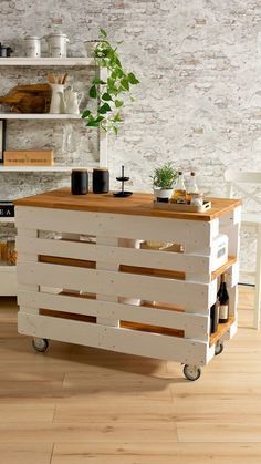 a kitchen island made out of pallet wood with wheels on the bottom and shelves above it