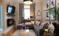 a living room filled with furniture and a flat screen tv mounted on the wall above it