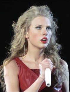 a woman in a red dress holding a white object