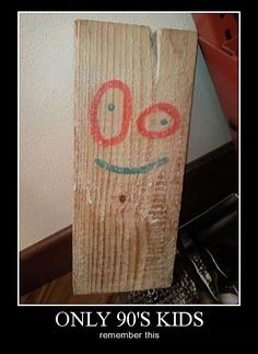 a piece of wood that has been painted with the word oo on it and an image of a smiling face