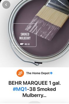 a paint can with a brush in it and the words behr marquee 1 gal