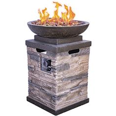 an outdoor fire pit with rocks on top