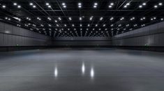 an empty parking garage with lights on the ceiling