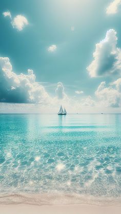 a sailboat floating in the ocean on a sunny day with blue sky and clouds