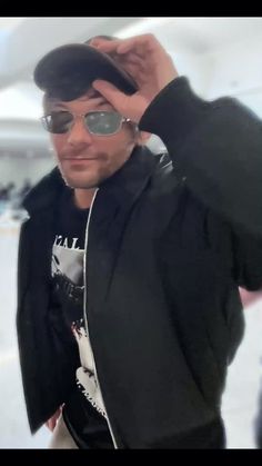 a man wearing sunglasses and a black jacket