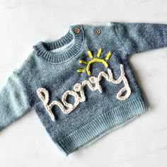 Baby, toddler and kids unisex 100% cotton chunky knitted sweater/jumper, personalised hand embroidery gift for baby and children. This ombré cotton sweater is practical, cute and a great personalised gift idea. Perfect for kids birthdays, Easter presents, winter wardrobe, baby shower present, new baby gift, gender reveal party, big brother or sister present, pregnancy announcement, matching sibling sweaters, birth announcement or any occasion! HOW TO ORDER: You can choose from the following options:  - Name embroidery (up to 8 letters, and up to 5 small flowers included(optional)) - Floral monogram initial  - Large daisy initial  - Big Sis/ Little Sis / Big Bro / Little Bro (any embroidery requiring more than 8 letters you will need to add on extra embroidery from my other listing) In the Baby Jumpers, Large Daisy, Ombre Sweater, Easter Presents, Diy Baby Clothes, Name Embroidery, Embroidery Sweater, Toddler Sweater, Baby Shower Presents