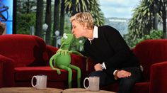 a person sitting on a couch with a kermie the frog in front of them