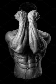 a black and white photo of a man's back with his hands behind his head