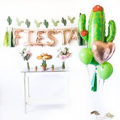 a cactus themed birthday party with balloons and decorations