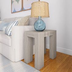 a living room with a white couch and two blue vases on the end tables