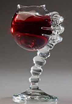 a wine glass with red liquid in it