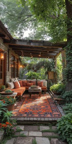 an outdoor living area with couches and rugs