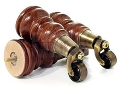 two wooden rollers with metal wheels on white background