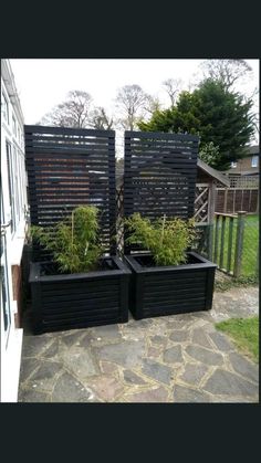 two black planters sitting next to each other