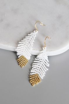 the white and gold beaded earrings
