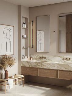 a bathroom with two sinks and mirrors on the wall next to a plant in a vase