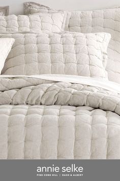 an image of a bed with white comforter and pillows