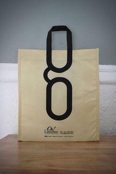 a bag with the number eight on it sitting on top of a wooden table next to a wall