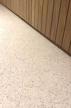 a white counter top sitting next to a wooden wall