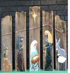 the nativity scene is painted on wooden boards