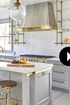 a kitchen with an island, stove and stools in the middle of the room