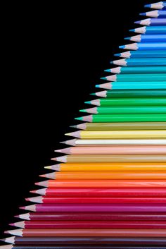 many colored pencils are arranged in the shape of a pyramid