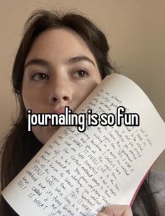 a woman holding an open book with the words journaling is so fun
