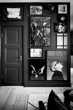 a black and white room with pictures on the wall