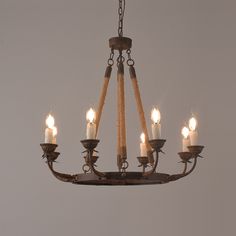 a chandelier with five lit candles hanging from it