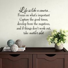 a wall decal that says life is like a camera focus on what's important capture the good times, develo from the negatives, and if things don't work out, take another shot