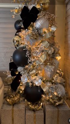 a christmas tree with black and gold ornaments