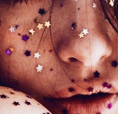 a girl with stars on her face and nose