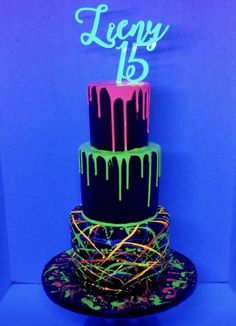 a three tiered cake with neon lights on it's sides and the words happy 13th