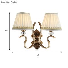 This sconce is perfect to light up any traditional styled living room. It comes complete with a beautiful gold fabric pleated shade and a dazzling crystal accent. The fixture stands 11 inches tall and is a wall-mounted light. It requires a direct wired electric supply and can take either an LED, incandescent, or fluorescent bulb. The shade itself is made from durable fabric.Size: 10 to 14 Inch 5 to 9 Inch Fixture Width: 12" 6.5" Fixture Height: 10 to 14 Inch Bulb Included: No Number of Lights: 2 Shade Wall, Pendant Wall Lights, Light Fixtures Bedroom Ceiling, Ceiling Lamps Bedroom, Outdoor Wall Lamps, Wood Shades, Bedroom Ceiling Light, Traditional Fabric, Wall Mounted Light