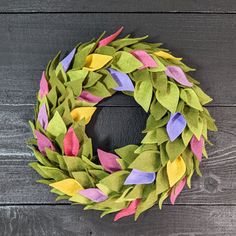 a wreath made out of felt sitting on top of a wooden table